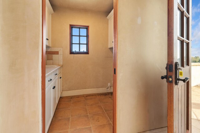 bathroom featuring tile patterned flooring, baseboards, and vanity