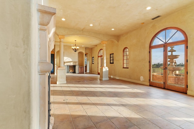 interior space featuring visible vents, light tile patterned floors, decorative columns, and recessed lighting