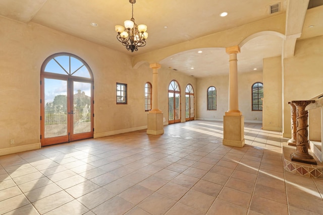 interior space with french doors, tile patterned flooring, visible vents, and ornate columns