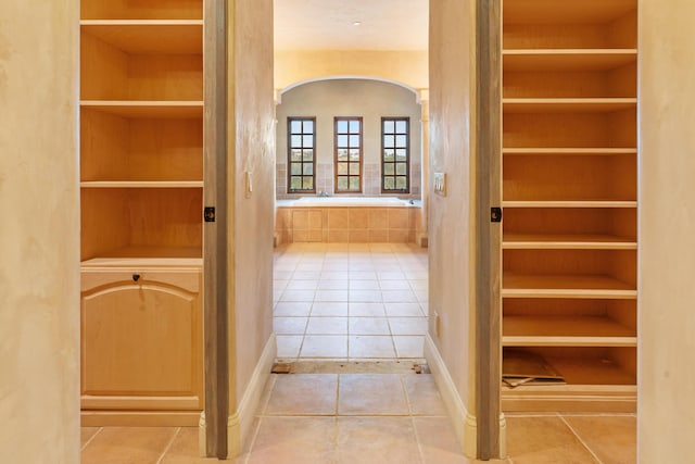 interior space with baseboards and tile patterned floors