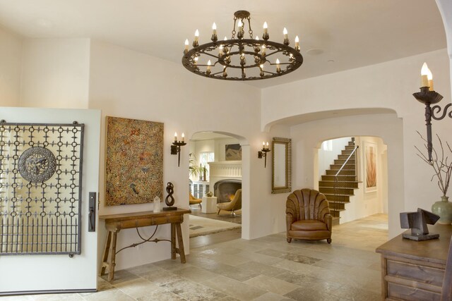 interior space featuring light tile patterned floors and a chandelier