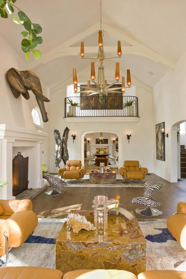 living room featuring high vaulted ceiling and wood-type flooring