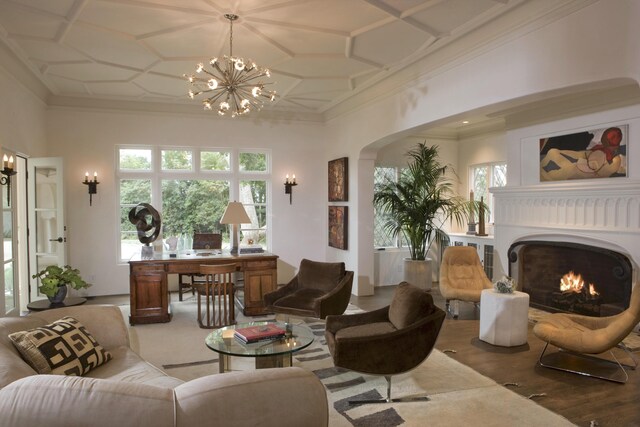 interior space with hardwood / wood-style flooring, coffered ceiling, a notable chandelier, and crown molding