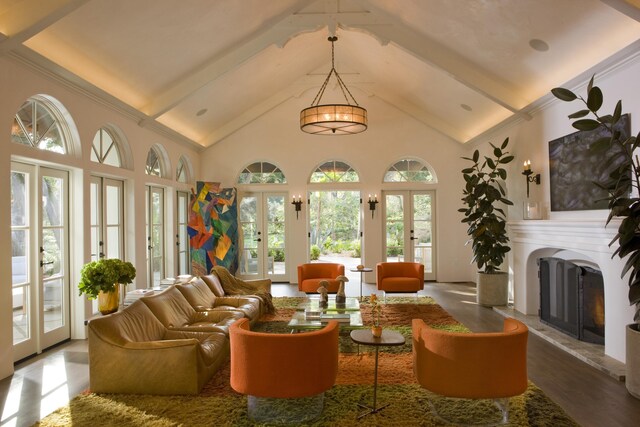 living room with hardwood / wood-style flooring, french doors, and high vaulted ceiling