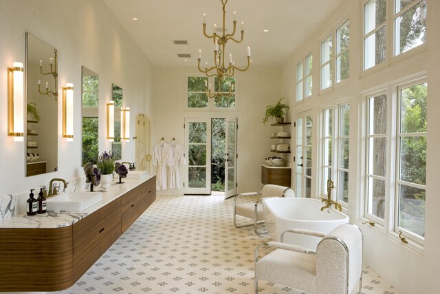 interior space featuring sink, an inviting chandelier, and a healthy amount of sunlight