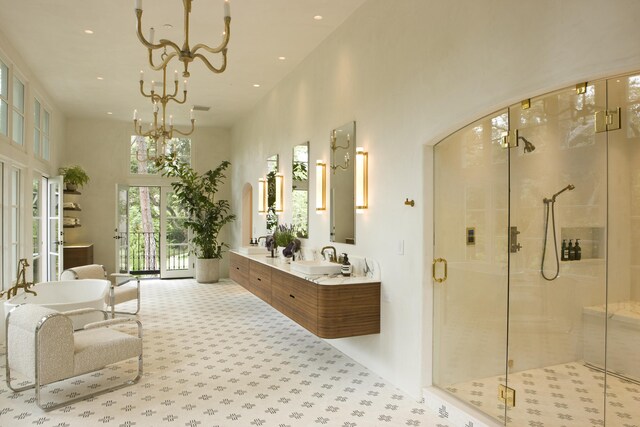 bathroom with independent shower and bath, vanity, and a high ceiling