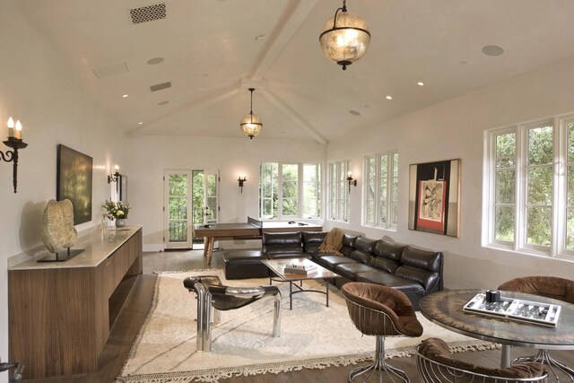 living room with hardwood / wood-style floors, beam ceiling, and high vaulted ceiling