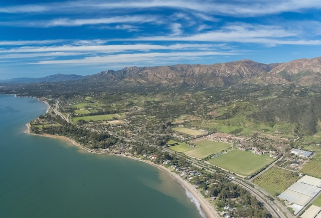 birds eye view of property with a water and mountain view