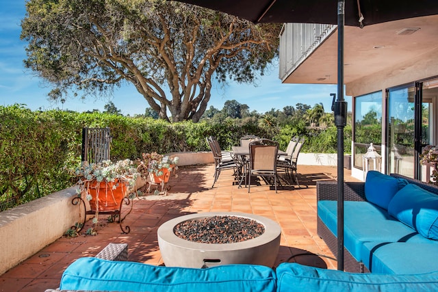 view of patio / terrace featuring an outdoor living space with a fire pit