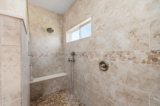 bathroom with a tile shower