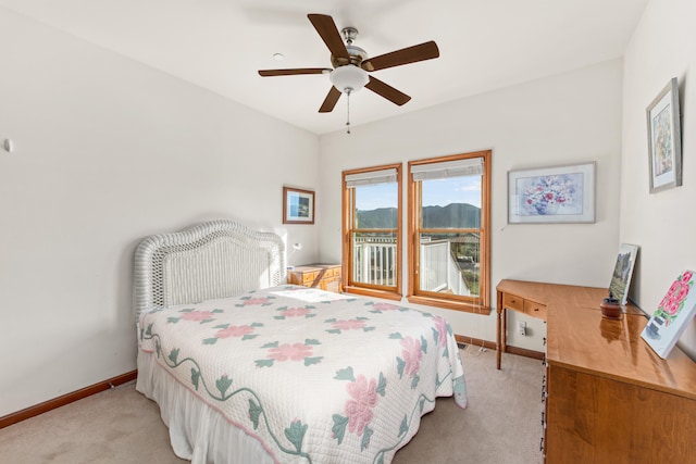 bedroom featuring ceiling fan and light carpet