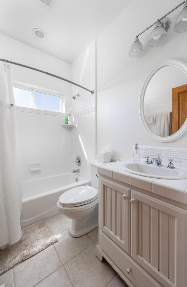 full bathroom featuring vanity, toilet, tile patterned floors, and shower / bath combo