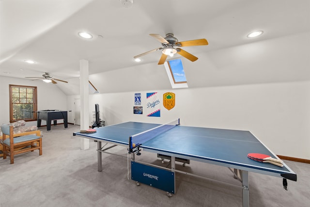 recreation room featuring ceiling fan, carpet floors, and lofted ceiling with skylight