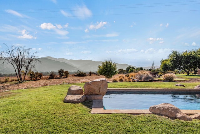 exterior space featuring a mountain view and a lawn