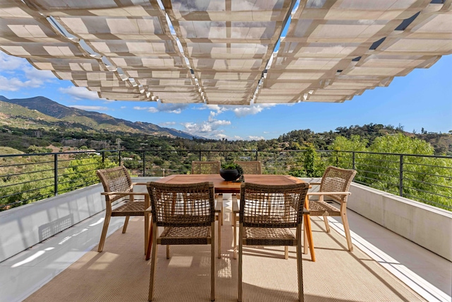 balcony featuring a mountain view and a pergola