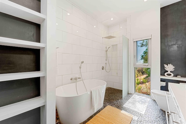 bathroom with toilet, built in features, plus walk in shower, and tile walls