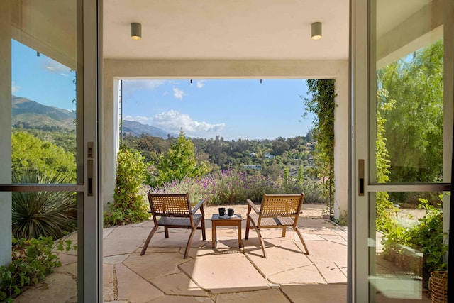 sunroom / solarium featuring a mountain view