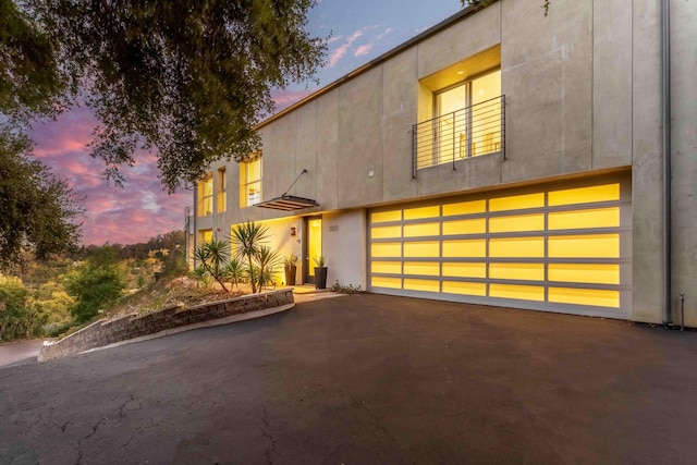 modern home featuring a garage and a balcony