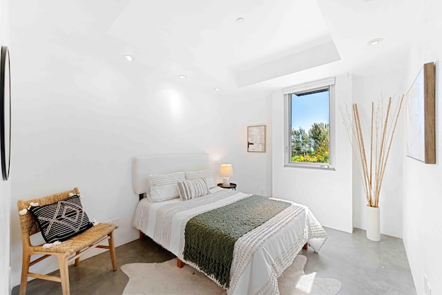 bedroom featuring concrete flooring