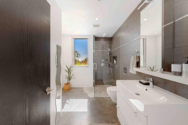 bathroom featuring an enclosed shower, vanity, toilet, and concrete floors