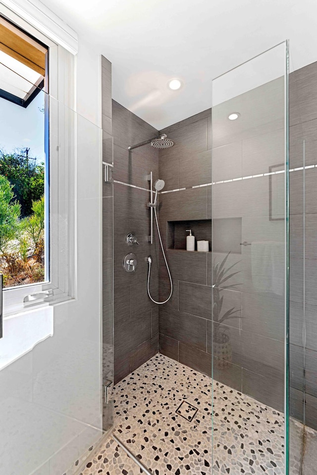 bathroom with a shower with shower door and tile patterned floors