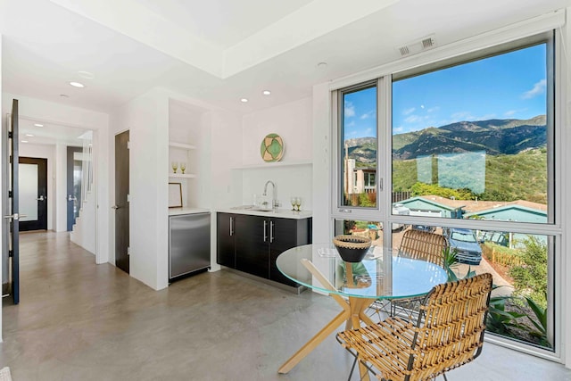 kitchen with a mountain view, stainless steel appliances, sink, and built in features