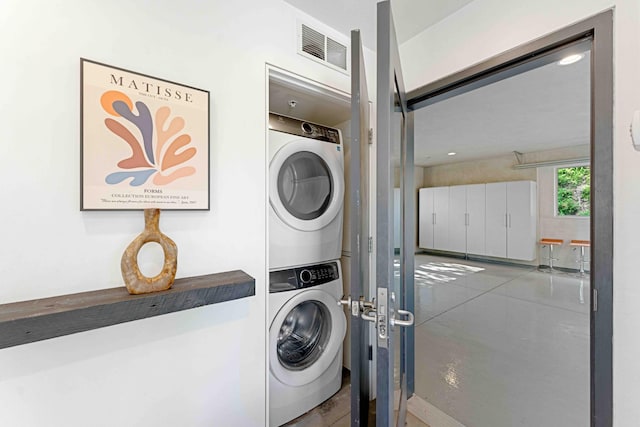 laundry room with stacked washer and clothes dryer