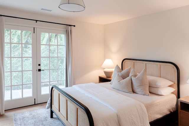 bedroom featuring access to outside, french doors, and light hardwood / wood-style floors