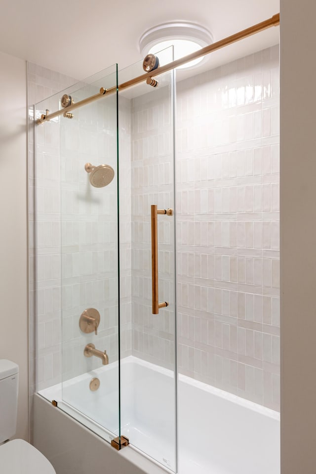 bathroom with toilet and enclosed tub / shower combo