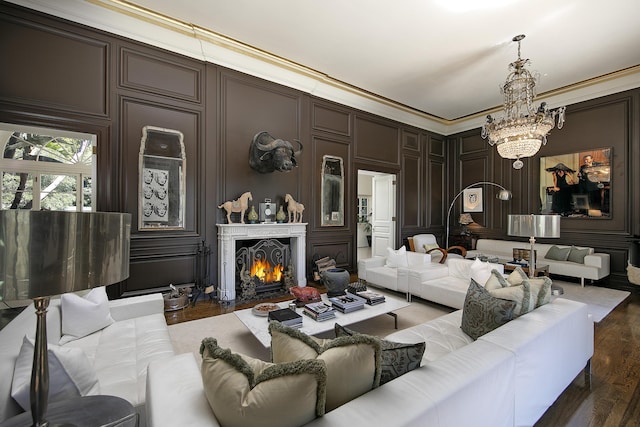 2925 Sycamore Canyon Rd, Montecito, CA 93108 - living area featuring a warm lit fireplace, a decorative wall, crown molding, wood finished floors, and a notable chandelier