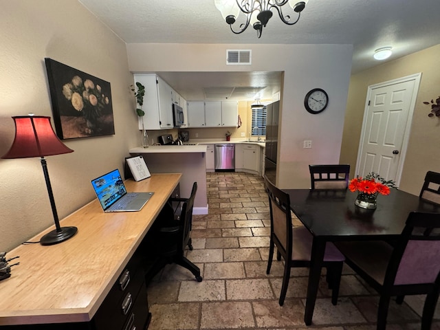 dining area featuring a notable chandelier and sink