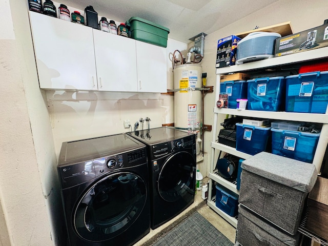 laundry room featuring a textured ceiling, cabinets, washer and clothes dryer, and secured water heater