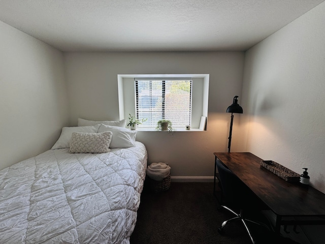 carpeted bedroom with a textured ceiling