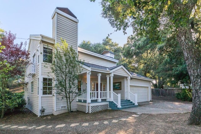 view of front of house featuring a porch and a garage