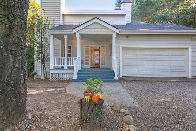 view of front of property featuring a garage and a porch