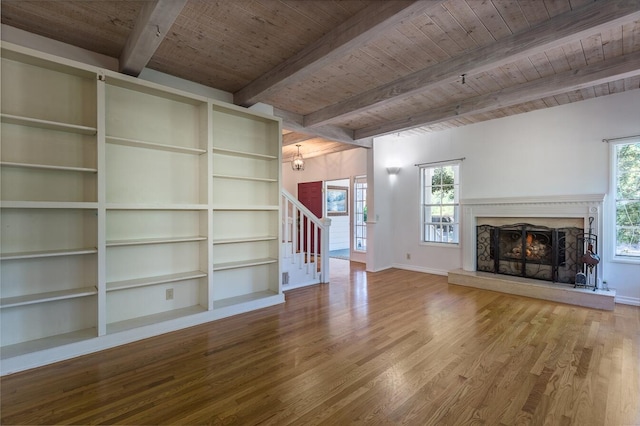 unfurnished living room featuring wood ceiling, a fireplace, beamed ceiling, and wood-type flooring