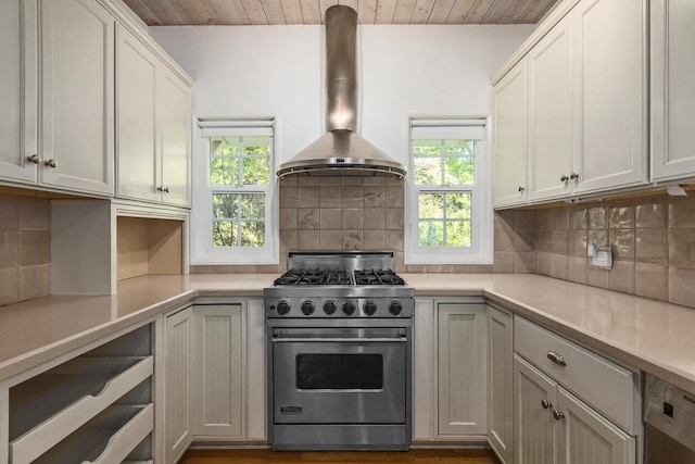 kitchen featuring a healthy amount of sunlight, appliances with stainless steel finishes, wall chimney exhaust hood, and wooden ceiling