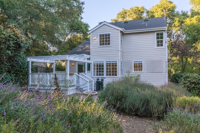 back of house with a deck and a pergola