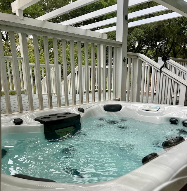 view of swimming pool with a deck and a hot tub