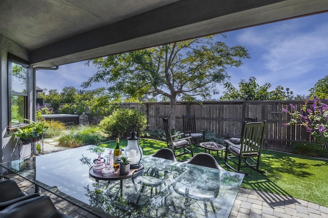 view of patio / terrace with a fenced backyard, a fire pit, and outdoor dining area