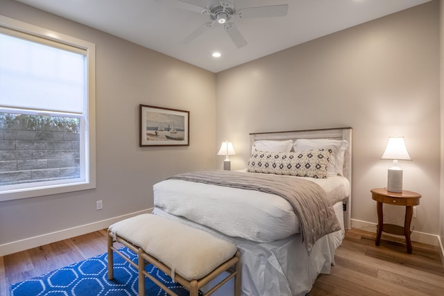 bedroom featuring a ceiling fan, recessed lighting, baseboards, and wood finished floors