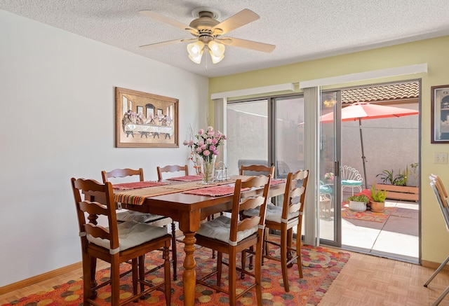 dining space featuring a textured ceiling, ceiling fan, and light parquet flooring