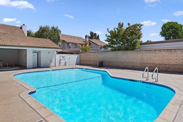 view of swimming pool featuring a patio area