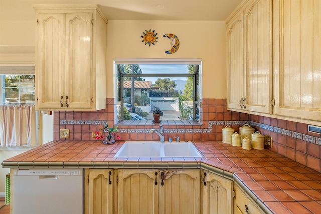 3050 Serena Rd, Santa Barbara, CA 93105 - kitchen featuring a healthy amount of sunlight, backsplash, white dishwasher, a sink, and tile counters