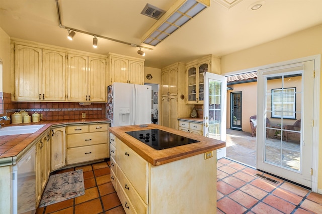 3050 Serena Rd, Santa Barbara, CA 93105 - kitchen with black electric stovetop, white refrigerator with ice dispenser, wood counters, visible vents, and dishwashing machine