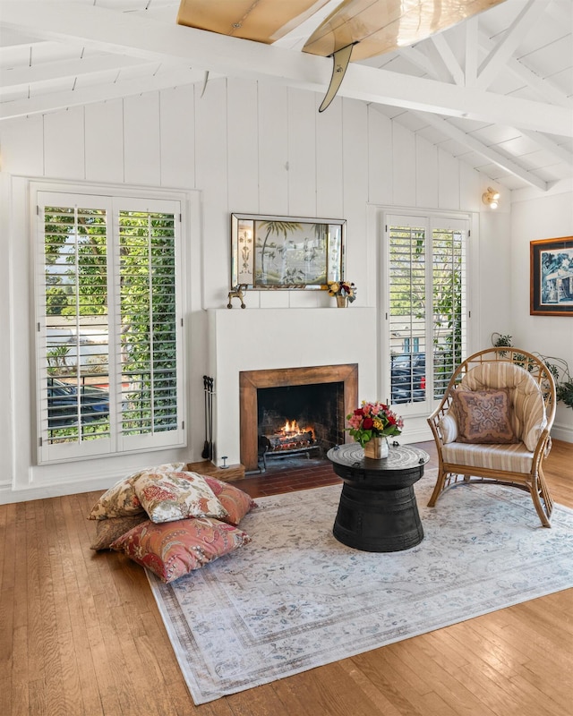 3050 Serena Rd, Santa Barbara, CA 93105 - living room with wood-type flooring, a fireplace with flush hearth, and vaulted ceiling with beams