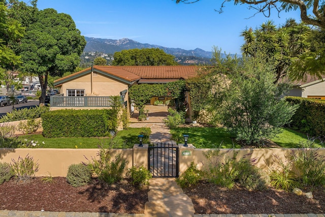3050 Serena Rd, Santa Barbara, CA 93105 - view of front facade with a mountain view, a fenced front yard, a gate, and stucco siding