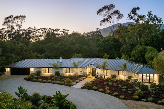 view of front of property with a mountain view and a garage