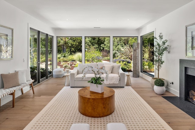 sunroom with a healthy amount of sunlight and a high end fireplace