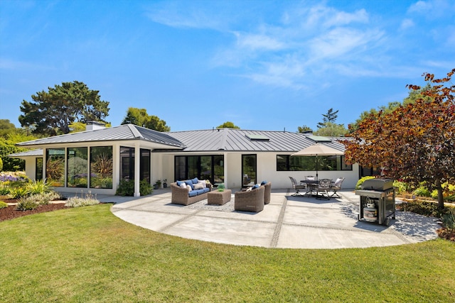 back of house featuring a lawn, an outdoor living space, and a patio area